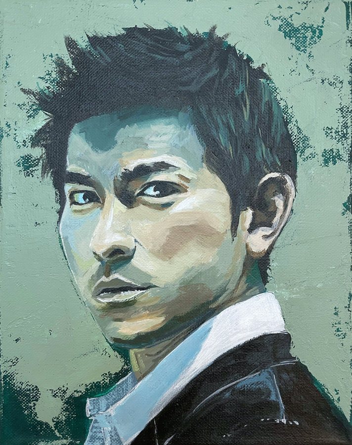 Portrait of a man in a dark jacket on sage green