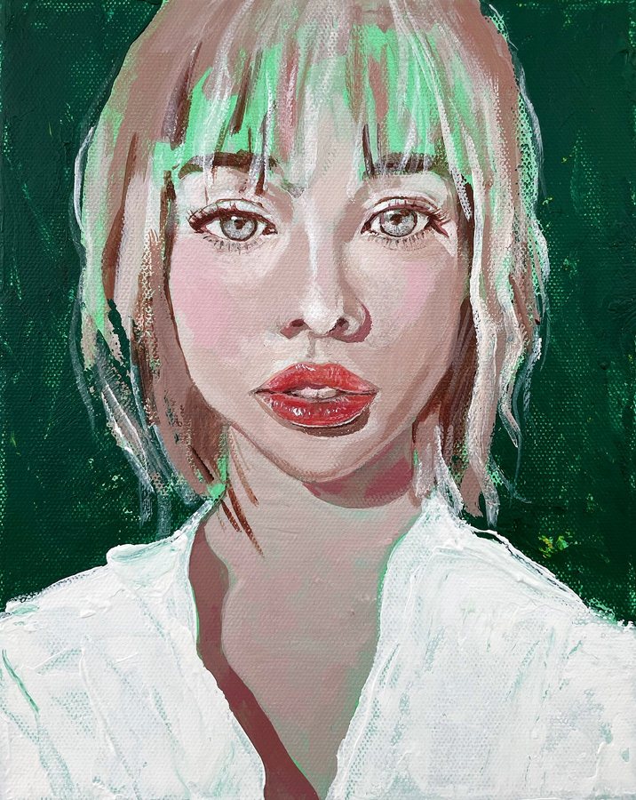 Portrait of a young woman with a fringe on deep green