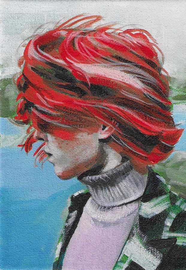 Profile of a person with windswept red hair in a turtleneck, by the sea