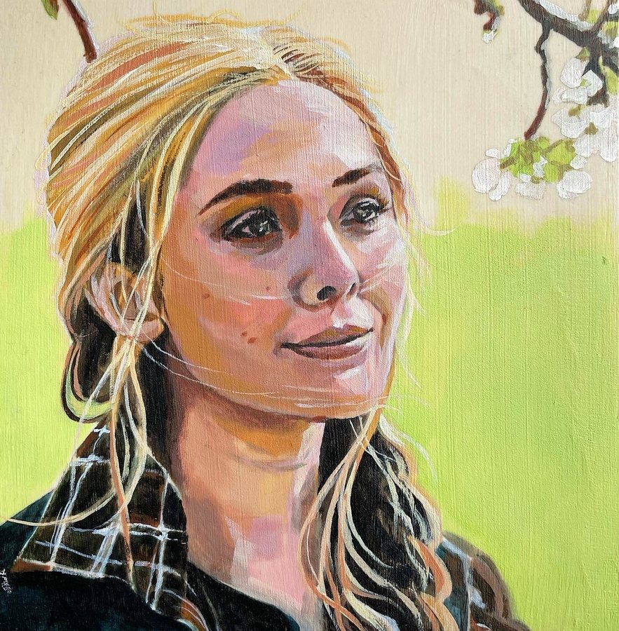 Portrait of a smiling woman with blonde braids