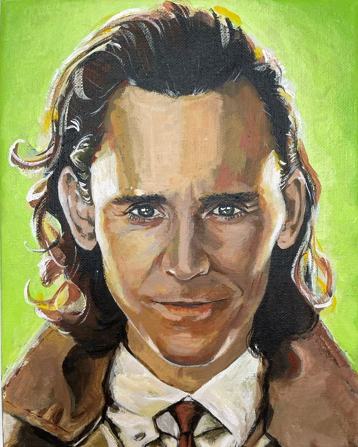 A smiling man with long dark hair on bright green