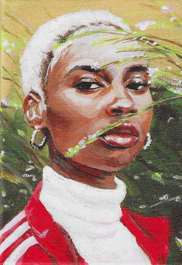 Portrait of a woman with short white hair behind grass