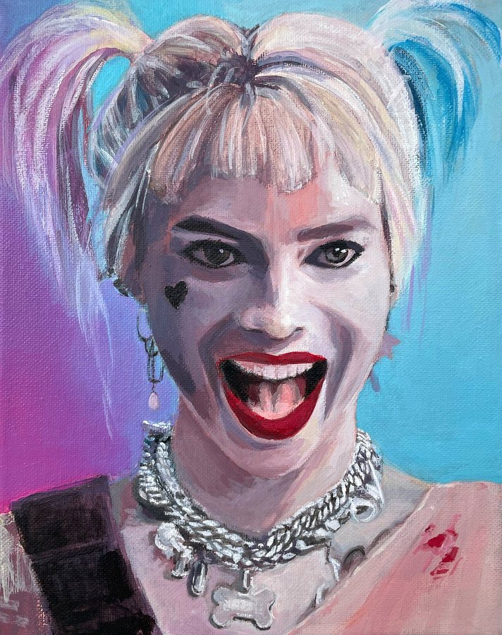 A laughing woman with pink and blue pigtails