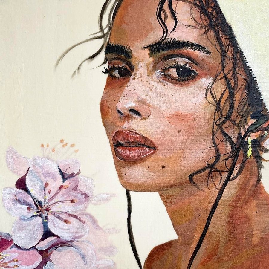 Portrait of a woman beside pink blossoms