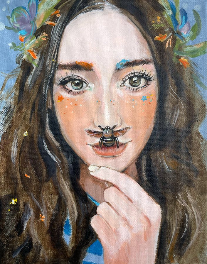 A woman with flowers in her hair and a bee on her lip